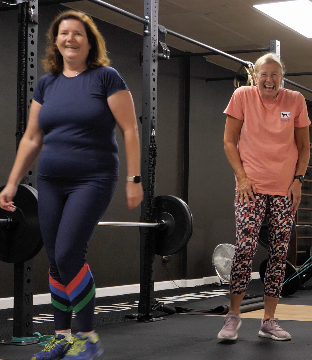 Group of midlife clients performing resistance exercises with professional guidance in a bright Cheltenham studio.