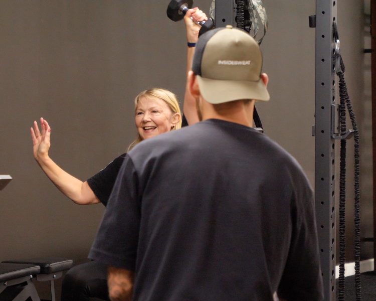 Personal trainer guiding a client through a strength training session at a private studio in Cheltenham, Gloucestershire