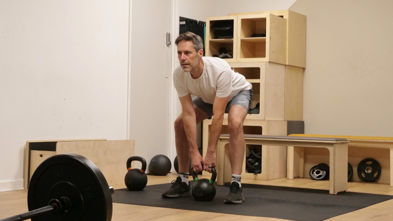 Man over 40 doing strength training at Insidesweat cheltenham to improve fitness and reduce joint pain.